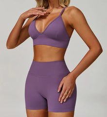 Person wearing a purple sports bra and shorts set - full view