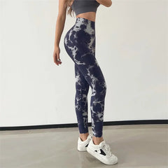 Person wearing tie-dye leggings and white sneakers