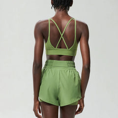 Person wearing a green sports bra and shorts set