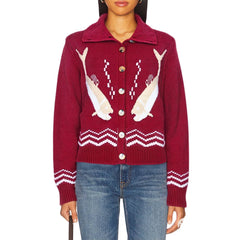 Red sweater with shark design worn by a person 