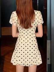Person wearing a polka dot dress with a blurred background