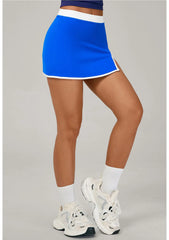 Person wearing a blue tennis skirt with white shoes and socks
