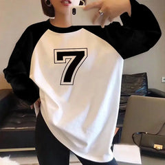 Person wearing a black and white long-sleeve shirt with the number 7.