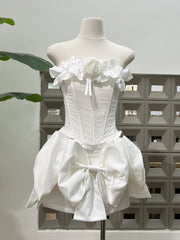White dress on a mannequin against a neutral background