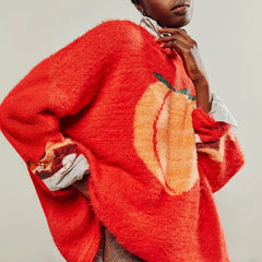Person wearing a red sweater with a sun design on a plain background