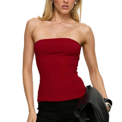 Woman wearing a strapless red top on a white background