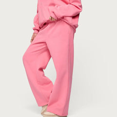 Person wearing a pink outfit on a light gray background