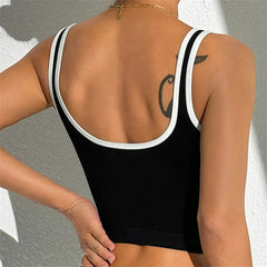 Black tank top with white trim worn by a person- back