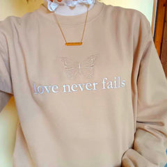 Women's embroidered sweatshirt with a butterfly and inspirational message.