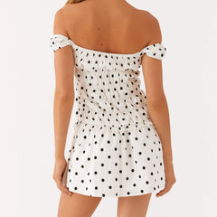 Women's off-shoulder mini dress with polka dots and ruching.