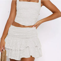 Woman wearing a light gray ruched top and skirt set 