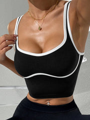 Black sports bra with white trim worn by a person- full view