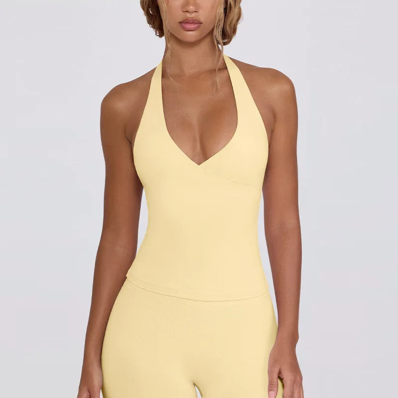 Woman wearing a yellow jumpsuit on a plain background