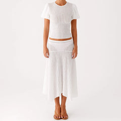Person wearing a white knit outfit 
