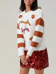 Person wearing a white sweater with brown stripes and red sequin skirt on a plain background