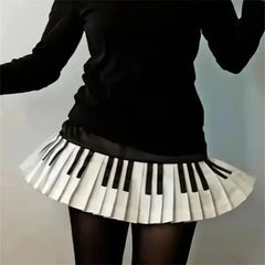 Person wearing a black top and a unique skirt with piano key design