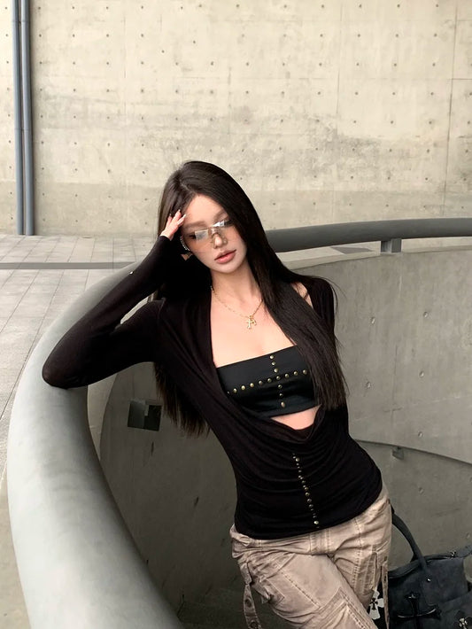 Women's black long sleeve cut out drape halter top with asymmetrical collar.

