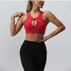 Woman wearing a red sports bra and black leggings- front