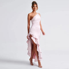 A satin long dress featuring a one shoulder design, ruffle accents, and an asymmetrical hem, shown on model.