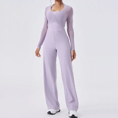 Person wearing a lavender jumpsuit on a light gray background
