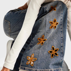 Denim jacket with embroidered orange flowers - close-up