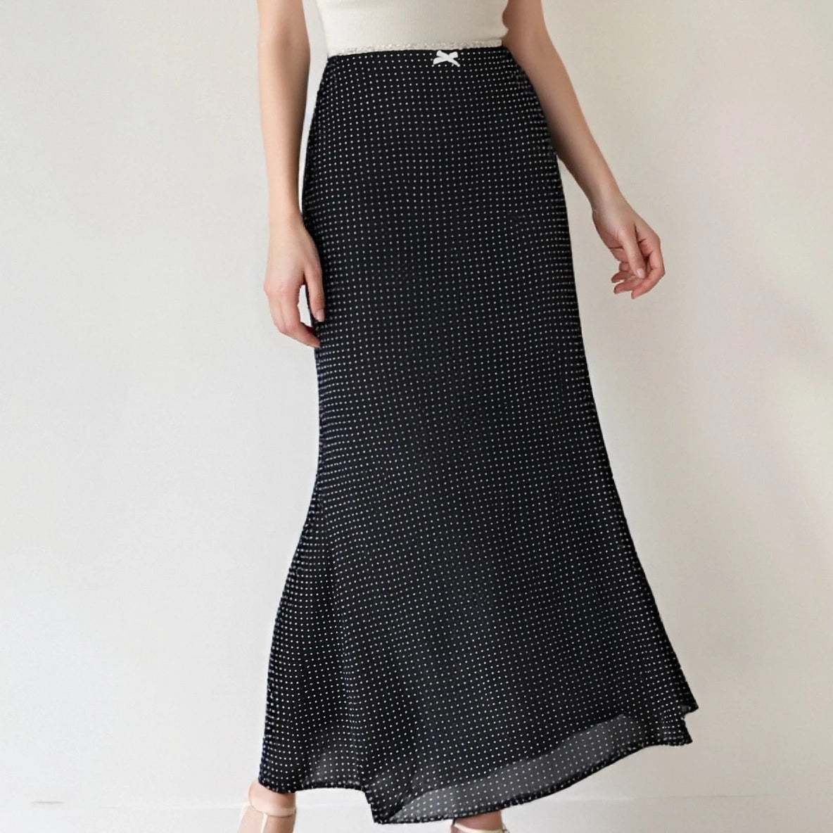 Black polka dot skirt worn by a person