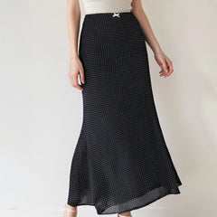 Black polka dot skirt worn by a person