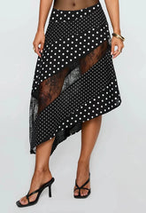 Black and white polka dot skirt with sheer overlay on a plain background