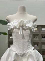White corset dress on a mannequin against a neutral background