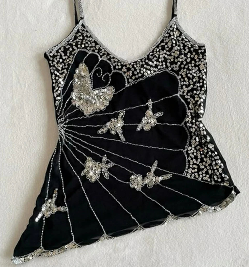 Black dress with silver embellishments on a white background