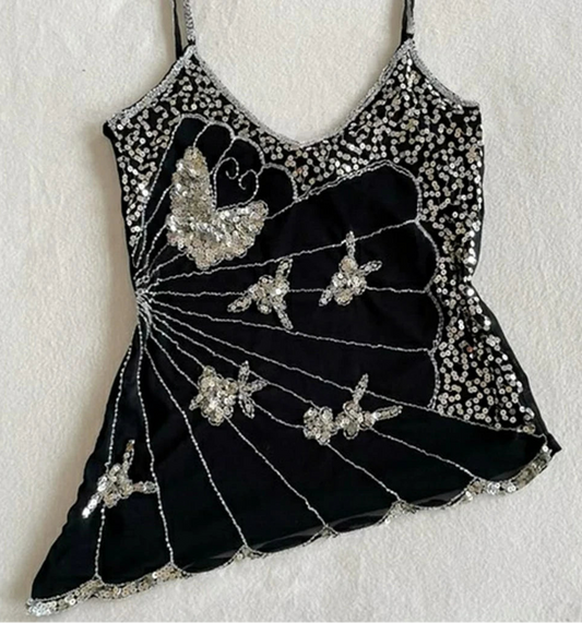 Black dress with silver embellishments on a white background