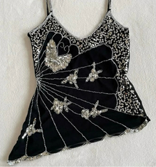 Black dress with silver embellishments on a white background