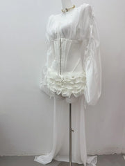 White lace dress on a mannequin against a plain background