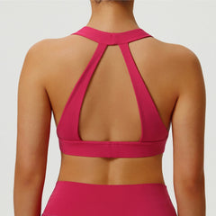 Pink sports bra and shorts on a plain background