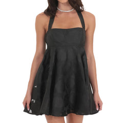 Black dress worn by a model on a white background