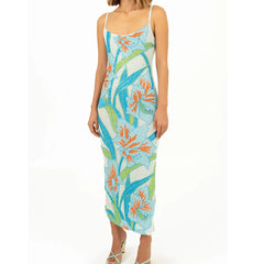 Woman wearing a floral dress with blue, orange, and green patterns 