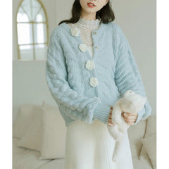 Women's cardigan with rose button details.