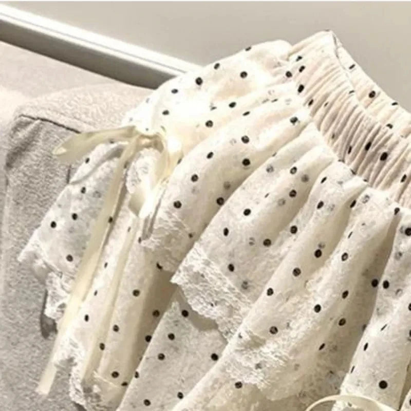 Women's white polka dots elastic mini skirt with a bow.

