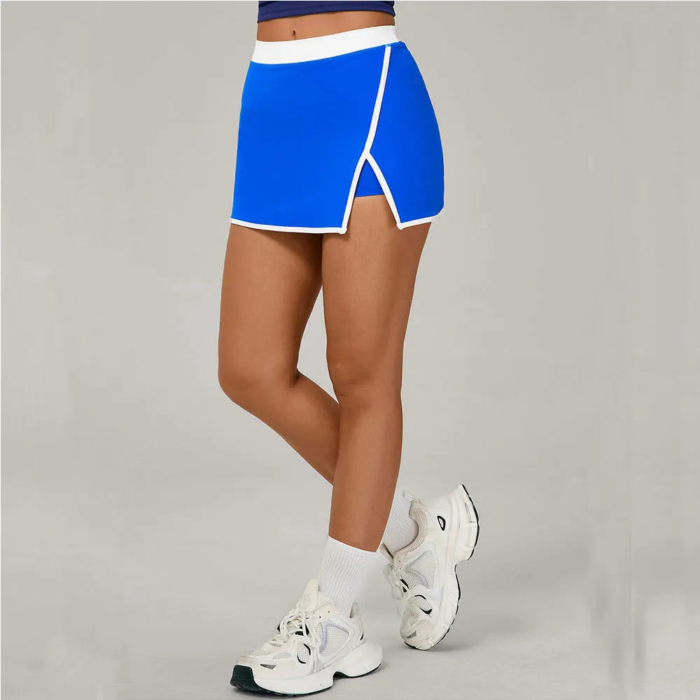 Person wearing a blue skirt and white sneakers 