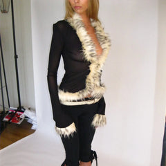 Person wearing a black outfit with a white fur trim