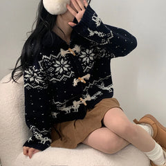 Person wearing a black and white patterned sweater sitting 