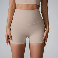 Beige shapewear shorts worn by a person - front view