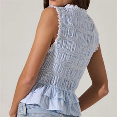 Light blue ruffled top worn by a person on a plain background
