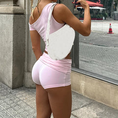 Women's light pink solid crop top and matching shorts set with off-shoulder top and ruched details.

