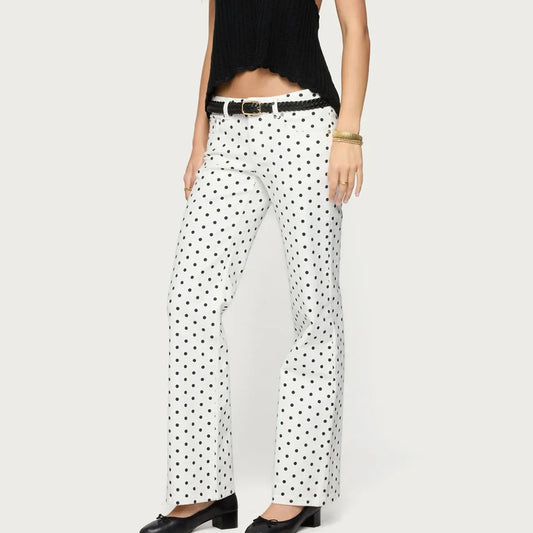 White pants with black polka dots worn by a person on a white background