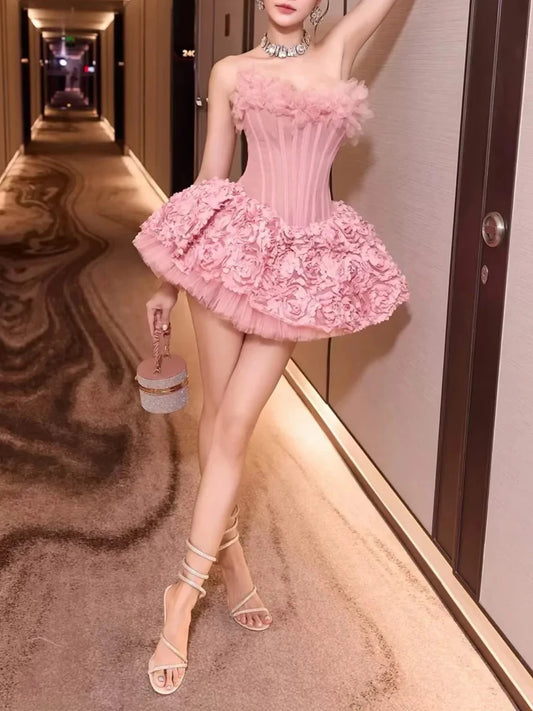Woman in a pink dress standing in a hallway