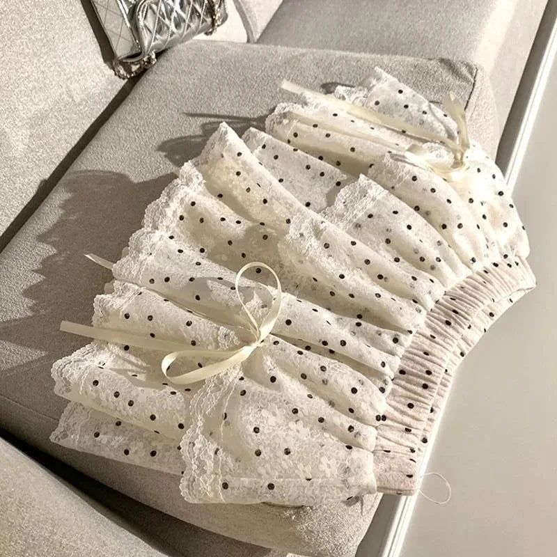 Women's white polka dots elastic mini skirt with a bow.

