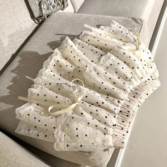 Women's white polka dots elastic mini skirt with a bow.

