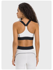 Woman wearing a black and white sports bra and leggings- back view