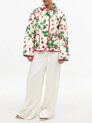 Person wearing a patterned jacket and white pants 